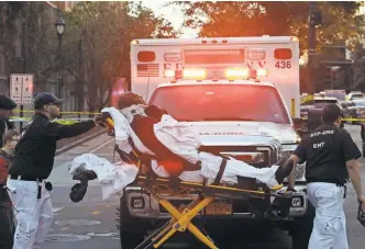  ?? MARK LENNIHAN/ AP ?? Emergency personnel transport a man on a stretcher after a motorist drove onto a bicycle path near the World Trade Center and struck several people Tuesday.