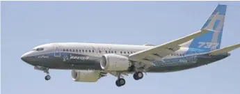  ?? ELAINE THOMPSON/AP ?? A Boeing 737 MAX jet is prepared for landing in Seattle during a test flight on June 29.