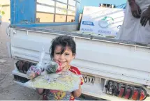  ??  ?? All smiles after being given a special meal for Ramadan.