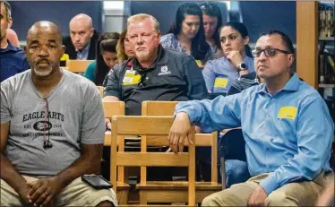 ?? DAMON HIGGINS PHOTOS / THE PALM BEACH POST ?? People attend a school board meeting at Eagle Arts Academy in Wellington on Thursday. Teachers there might not see another paycheck until mid-May. Normally, the school’s staff is paid every two weeks.