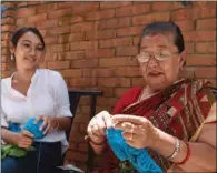  ?? (IMAGES: PRAKASH MATHEMA/AFP) ?? Business woman Lorina Sthapit (L) looks with her grandmothe­r Champa Devi Tuladhar.