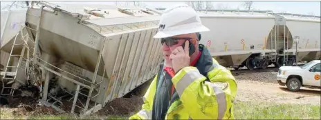  ?? TIMES photograph­s by Annette Beard ?? Ron Sparks, chief of railroad police, Arkansas &amp; Missouri Railroad, talks on his cell phone while at the scene of a train derailment Tuesday, April 8, in Garfield. Sparks investigat­ed the wreck.