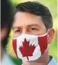  ?? AP ?? William Amos wears a Canadian flag mask.