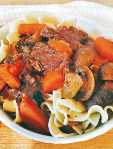  ?? ELIZABETH KARMEL /THE ASSOCIATED PRESS ?? This Burgundy Beef Stew was made with an electric pressure cooker. Serve the stew over egg noodles, mashed potatoes or gnocchi for a satisfying cold-weather meal.
thickened, stirring frequently.