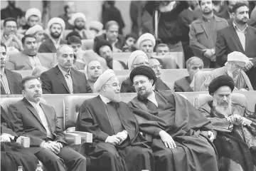  ??  ?? Rouhani (second left) sits next to Hassan Khomeini, the grandson of the Islamic Republic’s founder Ayatollah Ruhollah Khomeini, during a ceremony commemorat­ing the death of Ruhollah Khomeini’s son, in Tehran. — Reuters photo