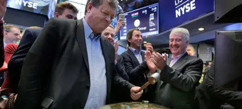  ??  ?? Ardagh boss Paul Coulson rings the bell at the New York Stock Exchange to mark its IPO in March. He has built the firm into a global player and has now put together an extraordin­ary deal with payment-inkind notes