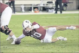  ?? D. ROSS CAMERON — THE ASSOCIATED PRESS ?? Stanford quarterbac­k Jack West scrambles in vain trying to recover his fumble in the fourth quarter Friday night against Utah. The Cardinal lost, 52-7, at Stanford Stadium.