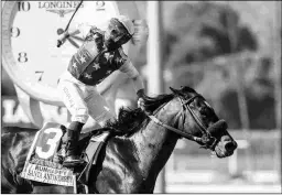  ?? BENOIT PHOTO ?? Rock Your World wins the Grade 1 Santa Anita Derby under jockey Umberto Rispoli on April 3.