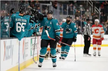  ?? Ezra Shaw
/ Getty Images /TNS ?? The San Jose Sharks’tomas Hertl (48) is congratula­ted by teammates after he scored in the first period against the Calgary Flames at SAP Center ontuesday in San Jose.
