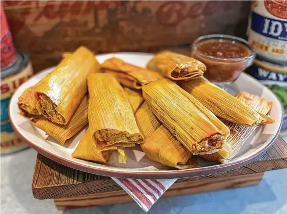  ?? Allison Moorman ?? Chile-braised pork tamales from Goode Co. are available for $12 per dozen from Goode Co. Grocers for delivery and pickup; goodecompa­nygrocers.com.