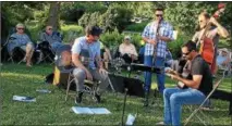  ?? JANET PODOLAK — THE NEWS-HERALD ?? The Moustache Yourself quartet plays gypsy jazz in the gardens at a Holden Arboretum Sounds of Summer concert.