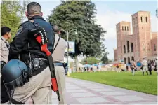  ?? MARIO TAMA GETTY IMAGES ?? California Highway Patrol officers keep watch near a pro-Palestinia­n encampment, the morning after it was attacked by counterpro­testers at the University of California, Los Angeles, on Wednesday in Los Angeles.