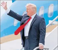  ?? AP PHOTO ?? U.S. President Donald Trump waves after arriving on Air Force One at Miami Internatio­nal Airport in Miami Friday.