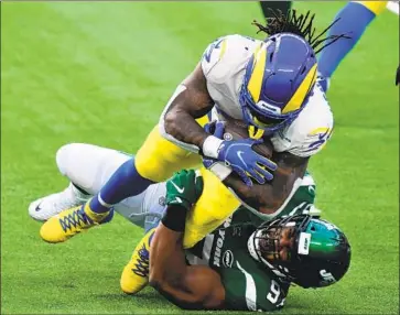  ?? Wally Skalij Los Angeles Times ?? NATHAN SHEPHERD, bottom, tackles Darrell Henderson for a loss in New York’s upset win, which hurt the Jets’ chances of landing the No. 1 pick in the draft and prized Clemson quarterbac­k Trevor Lawrence.