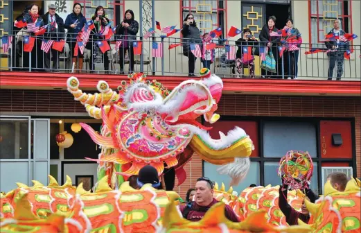  ??  ?? Airmen from Beale Air Force Base perform as the dragon Hong Wan Lung during the 136th annual Bok Kai Festival on Saturday in Marysville.