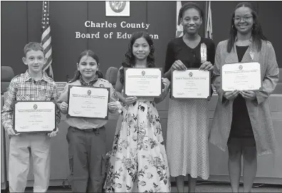  ?? SUBMITTED PHOTO ?? The Charles County Board of Education at its March 12 meeting honored five Charles County Public Schools students for accomplish­ments in the area of academic achievemen­t, career readiness and personal responsibi­lity. Honored, from left, were Griffin Birmingham, fifth-grade student, T.C. Martin Elementary School; Amy Costa, fifth-grade student, Dr. Gustavus Brown Elementary School; Lilibeth Pineda-Mendez, fourth-grade student, C. Paul Barnhart Elementary School; Angelica Proctor, eighth-grade student, John Hanson Middle School; and Lashauna Barbour, senior, Henry E. Lackey High School.