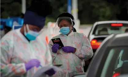  ?? Photograph: Brendan McDermid/Reuters ?? Medical technician­s work at a drive-through coronaviru­s testing facility in Tarrytown, New York, on 17 September 2020.