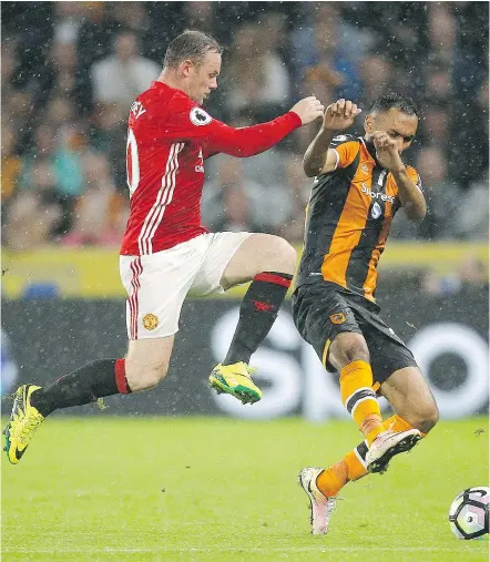  ?? — THE ASSOCIATED PRESS FILES ?? Manchester United’s Wayne Rooney, left, is being kept as England’s captain.