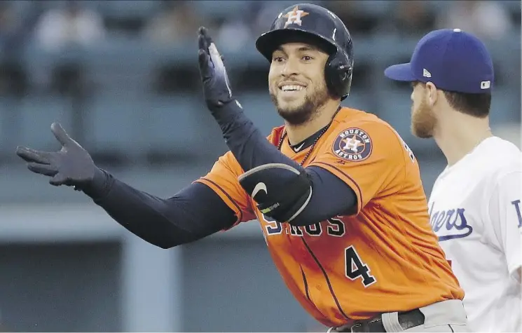  ?? DAVID J. PHILLIP/THE ASSOCIATED PRESS ?? Houston Astros outfielder George Springer is among a growing legion of pro athletes who pass the time playing Fortnite Battle Royale, a new video game that pits up to 100 competitor­s in a last-man-standing scenario.