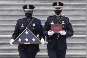  ?? MICHAEL REYNOLDS ?? An honor guard carries an urn with the cremated remains of U.S. Capitol Police officer Brian Sicknick down the steps of the U.S. Capitol in Washington.