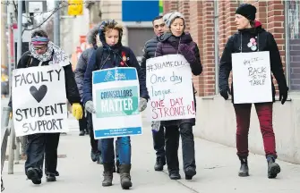  ??  ?? Teachers and faculty staff of the Ontario Public Service Employees Union walk the picket line at George Brown College in Toronto on Thursday.