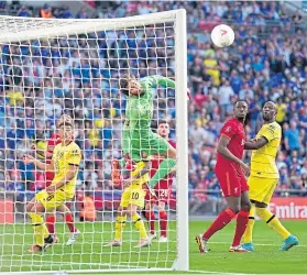  ?? ?? Alisson flies through the air as Chelsea put his goal under threat