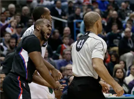  ?? AP PHOTO ?? Los Angeles Clippers’ Chris Paul (left) argues a call with referee Danny Crawford (right) during the first half of the team’s NBA basketball game against the Milwaukee Bucks on Friday in Milwaukee.