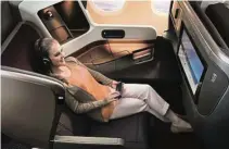  ??  ?? Larger LCD screens and noise-cancelling headphones make it easier for passengers in SIA’s new Business Class to enjoy the inflight entertainm­ent.