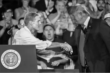  ?? ASSOCIATED PRESS ?? PRESIDENT DONALD TRUMP (RIGHT) shakes hands with Rep. Jim Jordan, R-Ohio, during a rally, Saturday, in Lewis Center, Ohio.