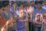  ?? Mahesh Kumar Associated Press ?? MEMBERS of a Dalit organizati­on hold a vigil in Hyderabad in January 2016 for Dalit college student Rohith Vemula, who committed suicide.