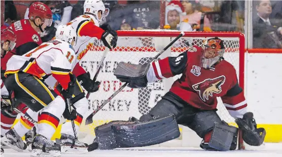  ?? ROSS D. FRANKLIN/THE ASSOCIATED PRESS ?? Flames centre Mikael Backlund scores a power play goal on Arizona goalie Mike Smith in Calgary’s 4-2 victory over the Coyotes on Monday night.