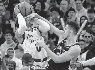  ?? Ronald Cortes/staff photograph­er ?? Russell Westbrook of the Lakers is fouled by San Antonio’s Zach Collins, who was given a flagrant 2 foul during the second half on Saturday at AT&T Center. Los Angeles won 143-138.