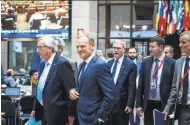  ?? Aurore Belot / AFP / Getty Images ?? European Commission President Jean Claude Juncker (left) and European Council President Donald Tusk arrive to address a press conference on the sidelines of the summit in Brussels.