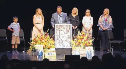  ?? ADOLPHE PIERRE-LOUIS/JOURNAL ?? Michael Riordan is joined by family members on Sunday at the memorial for his wife, Jennifer Riordan, who died last week after an airplane engine exploded midflight.