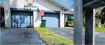  ?? CARLINE JEAN/SUN SENTINEL ?? A man bought a strip of land that is about one foot by 100 feet. From the front of the house it is a strip of grass that goes down the middle of a garage and through the backyard at 8107 NW 100th Way in Tamarac.