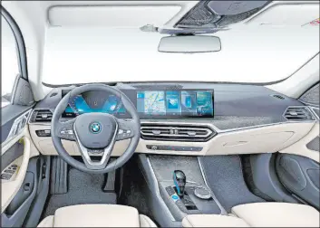  ?? ?? There’s a wide curved panel that houses a 12.3-inch instrument cluster and a 15inch touch screen. Since there are technicall­y no gears in the i4’s powertrain, the shift lever is more of direction changer.