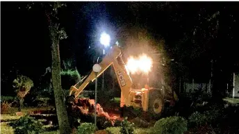  ??  ?? A backhoe is used to destroy the ‘Mullaivaik­al memorial” within the Jaffna University campus on Friday night.