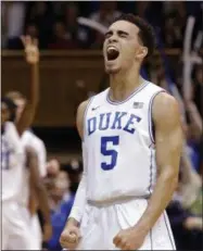  ?? GERRY BROOME — THE ASSOCIATED PRESS ?? Duke’s Tyus Jones (5) and Amile Jefferson (21), rear, react following Jones’ basket against Notre Dame during the first half of Saturday’s game.