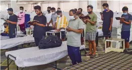  ?? — PTI ?? A group of Covid-19 infected Jewish people from Manipur offers prayers while undergoing treatment at the Guru Tegh Bahadur Covid Care Centre at Gurdwara Rakab Ganj Sahib in New Delhi on Tuesday. 38 new patients, all of whom are from Manipur and were staying at a hotel in Karol Bagh, were admitted to this Covid care centre on Monday. They were supposed to leave for Israel but couldn’t catch the flight after they were detected Covid positive.