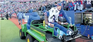  ?? BRETT CARLSEN/GETTY IMAGES ?? Buffalo quarterbac­k Tyrod Taylor is carted off the field during the fourth quarter of the Bills’ 23-3 loss to the New England Patriots on Sunday at New Era Field in Orchard Park, N.Y.