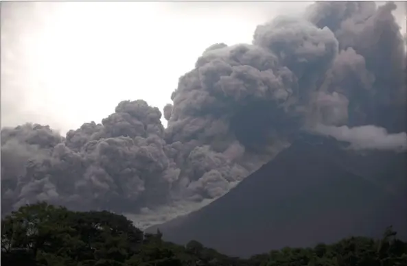  ?? AP PHOTO/SANTIAGO BILLY ?? Volcan de Fuego, or Volcano of Fire, blows outs a thick cloud of ash, as seen from Alotenango, Guatemala on Sunday. One of Central America’s most active volcanos erupted in fiery explosions of ash and molten rock Sunday, killing people and injuring...