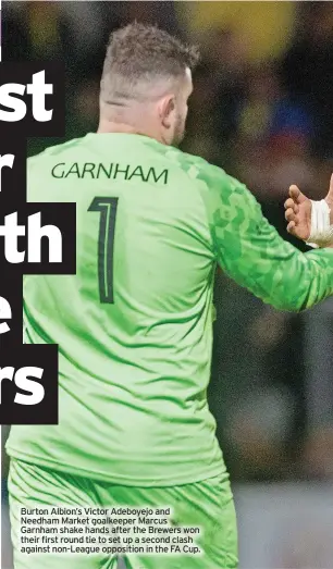  ?? ?? Burton Albion’s Victor Adeboyejo and Needham Market goalkeeper Marcus Garnham shake hands after the Brewers won their first round tie to set up a second clash against non-league opposition in the FA Cup.