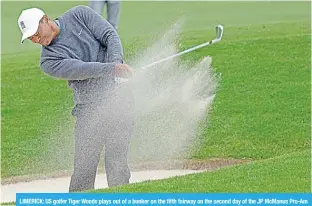  ?? ?? LIMERICK: US golfer Tiger Woods plays out of a bunker on the fifth fairway on the second day of the JP McManus Pro-Am golf tournament at the The Golf Course at Adare Manor in Limerick, south-west Ireland. —AFP