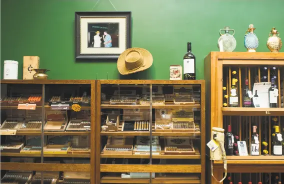  ??  ?? Above: Glass cases full of cigars at Hellam’s Tobacco Shop. At left: Nicaraguan cigars.