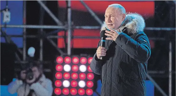  ?? ANDREY RUDAKOV
BLOOMBERG ?? Vladimir Putin, Russia's president, speaks to supporters during a rally near the Kremlin. Putin cruised to a landslide victory in Russia's presidenti­al vote.