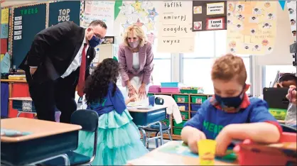  ?? Mandel Ngan / Associated Press ?? First lady Jill Biden and Education Secretary Miguel Cardona tour Benjamin Franklin Elementary School on Wednesday in Meriden. During the visit, Cardona announced vaccinatin­g teachers is his “top priority.”