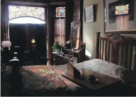  ??  ?? Coloured light spills into the second bedroom, possibly the bedroom of Jessie Dunsmuir, at Craigdarro­ch.