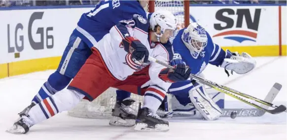  ?? CARLOS OSORIO/TORONTO STAR ?? Leafs goalie Curtis McElhinney gets the paddle down to deny Brandon Saad of the Blue Jackets on a wraparound attempt in Sunday night’s regular season finale at the Air Canada Centre.