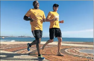  ?? Picture: GILLIAN McAINSH ?? FOR THE LOVE OF RUNNING: Committed parkrunner­s Henry Pienaar, left, and Werner de Lange celebrate parkrun’s 13th birthday at the PE Hobie Beach event