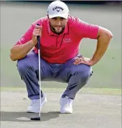  ?? CURTIS COMPTON/CURTIS.COMPTON@AJC.COM ?? Jon Rahm looks over his putt on the 18th green Sunday on the way to his final-round 66, which landed him in fifth place.